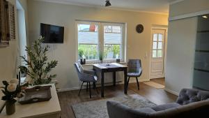 a living room with a table and chairs and a window at Ferienwohnung Pollig in Rech