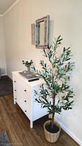 a white dresser with a tree in a room at Ferienwohnung Pollig in Rech +20 photos