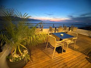 a patio with a table and chairs on a deck at Hotel Kappa3 Villas in Vlorë