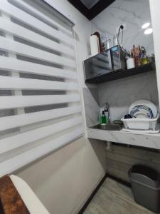 a small kitchen with a window and a sink at Cozy Studio Rohrmoser in San José +11 photos