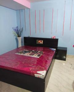 a room with a bed with a red table at Darshan Stay in Trichūr