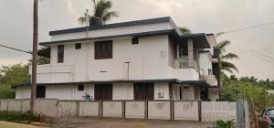 a white house with a fence in front of it at Darshan Stay in Trichūr