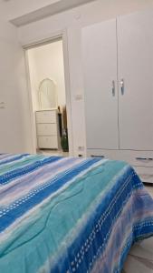 a bedroom with a bed and a dresser and a mirror at Casa Jenny sul mare in Scalea