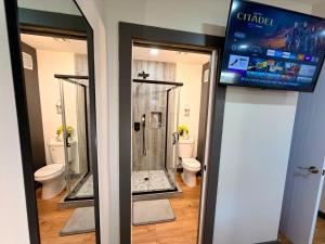 a bathroom with two toilets and a walk in shower at BP STAYS - Hotel-Style, No Host, Professionally Managed ID312 in Jersey City