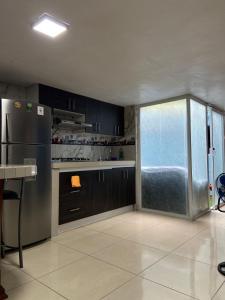 a kitchen with a stainless steel refrigerator and a window at Dalejadrohouse in Baños