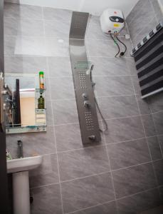 a shower in a bathroom with a tile floor at Radores Apartment in Ayobo +7 photos