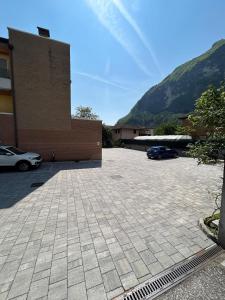 a parking lot in front of a building with a car at Le Mele - Alle 5 Torri in Mezzolombardo +4 photos