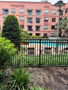 a black fence with a pool in front of a building at The Experience in Houston