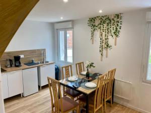 a kitchen and dining room with a table and chairs at Jasmin in Saint-Aignan +33 photos