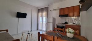 a kitchen and dining room with a table and chairs at 5 Suites Αγιόκαμπος Αγίας in Agiokampos