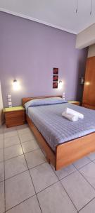 a bedroom with a large bed in a room at 5 Suites Αγιόκαμπος Αγίας in Agiokampos
