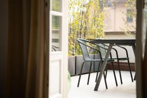 a table and chairs sitting on a balcony at Uno - Via Loveno, Menaggio by LoveComo in Menaggio