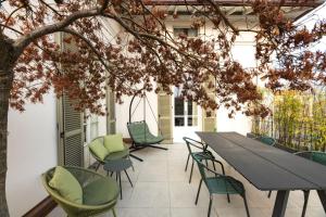 an outdoor patio with a table and chairs at Uno - Via Loveno, Menaggio by LoveComo in Menaggio