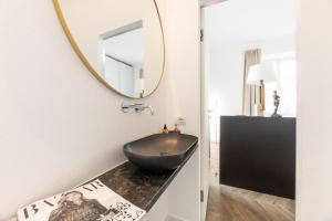 a bathroom with a black bowl sink and a mirror at Uno - Via Loveno, Menaggio by LoveComo in Menaggio +27 photos