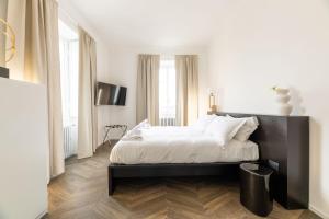 a bedroom with a large bed with a black headboard at Uno - Via Loveno, Menaggio by LoveComo in Menaggio