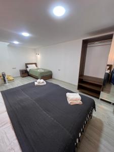 a room with a large bed in a room at Duplex Vakhrama in Abastumani