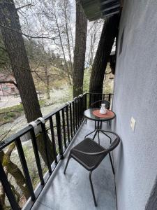 a small table and a chair on a balcony at Duplex Vakhrama in Abastumani