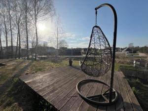 a swing on top of a wooden deck at Bebro namai in Vilnius +1 photo