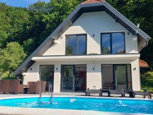 a house with a swimming pool in front of it at Kuca za odmor Moj Mir in Kalesija