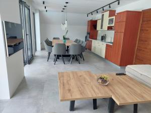 a dining room and kitchen with a table and chairs at Kuca za odmor Moj Mir in Kalesija