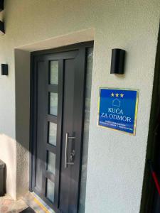 a door with a sign on the side of a building at Kuca za odmor Moj Mir in Kalesija +12 photos
