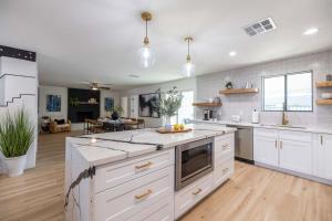 a large kitchen with white cabinets and a large island at Tempe Wesleyan in Tempe