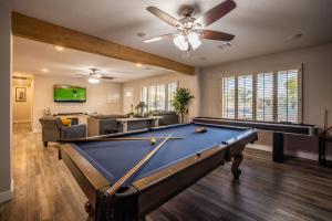 a pool table in a living room with a ceiling fan at Scottsdale Osborn in Scottsdale
