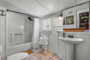 a bathroom with a sink and a toilet and a shower at Old Carrabelle Hotel Regatta Room in Carrabelle
