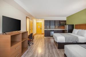 a hotel room with a bed and a flat screen tv at Best Western Kincardine in Kincardine