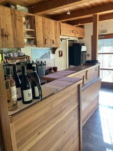 a kitchen with bottles of wine on a counter at Ferme de la Clarée in Névache