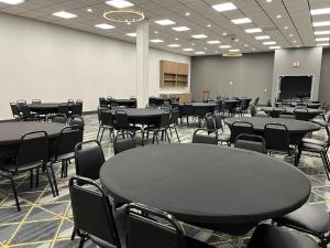 a large room with tables and chairs and a classroom at Holiday Inn Express Big Rapids by IHG in Big Rapids
