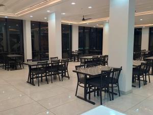 a dining area with tables and chairs in a building at Kanti empire in Dhaulpur