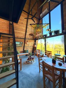 a living room with wooden walls and a table and chairs at Alpine Cabin PR 2026 in Tavera Abajo +34 photos