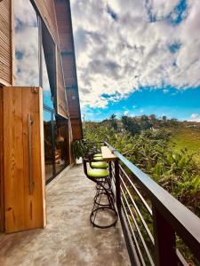 a balcony with a yellow chair on a building at Alpine Cabin PR 2026 in Tavera Abajo
