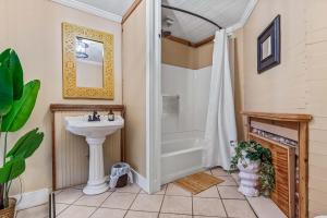 a bathroom with a shower and a sink at Old Carrabelle Hotel Hemingway Suite in Carrabelle