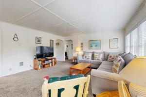 a living room with a couch and a tv at 2nd Tee at Neskowin Village in Neskowin
