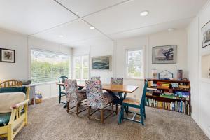 a room with a table and chairs and a book shelf at 2nd Tee at Neskowin Village in Neskowin +21 photos