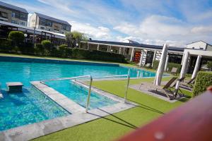 a large swimming pool in front of a building at Fynbos Lifestyle Estate - One Bed Apartment in Cape Town