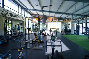 a gym with many treadmills and machines in it at Fynbos Lifestyle Estate - One Bed Apartment in Cape Town