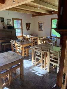a dining room with wooden tables and chairs at Ferme de la Clarée in Névache +16 photos