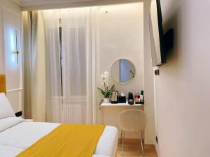 a hotel room with a bed and a mirror at Ciao Termini in Rome