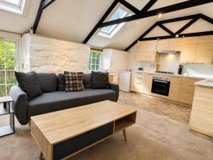 a living room with a couch and a table at Holiday Cottage Falmouth in Penryn +9 photos