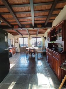 a kitchen with a table and a dining room at Casona Veroka in San Pedro