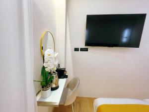 a room with a bed and a tv on a wall at Ciao Termini in Rome +25 photos