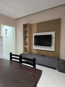 a living room with a flat screen tv on a wall at Kejdi Golem Central Apartment in Golem
