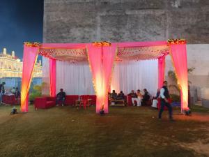 a group of people sitting under a pink tent at Kanti empire in Dhaulpur