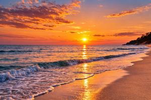 a beach at sunset with the sun setting over the ocean at Eden Apartament Jakuzzi, sauna in Rozewie