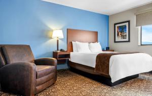 a hotel room with a bed and a chair at My Place Hotel-Missoula, MT in Missoula