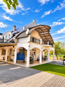 a large building with a gambrel roof at Hévíz Springs - Kehidakustány in Kehidakustány