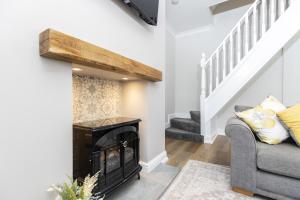 a living room with a fireplace and a staircase at High Lands in Cockfield